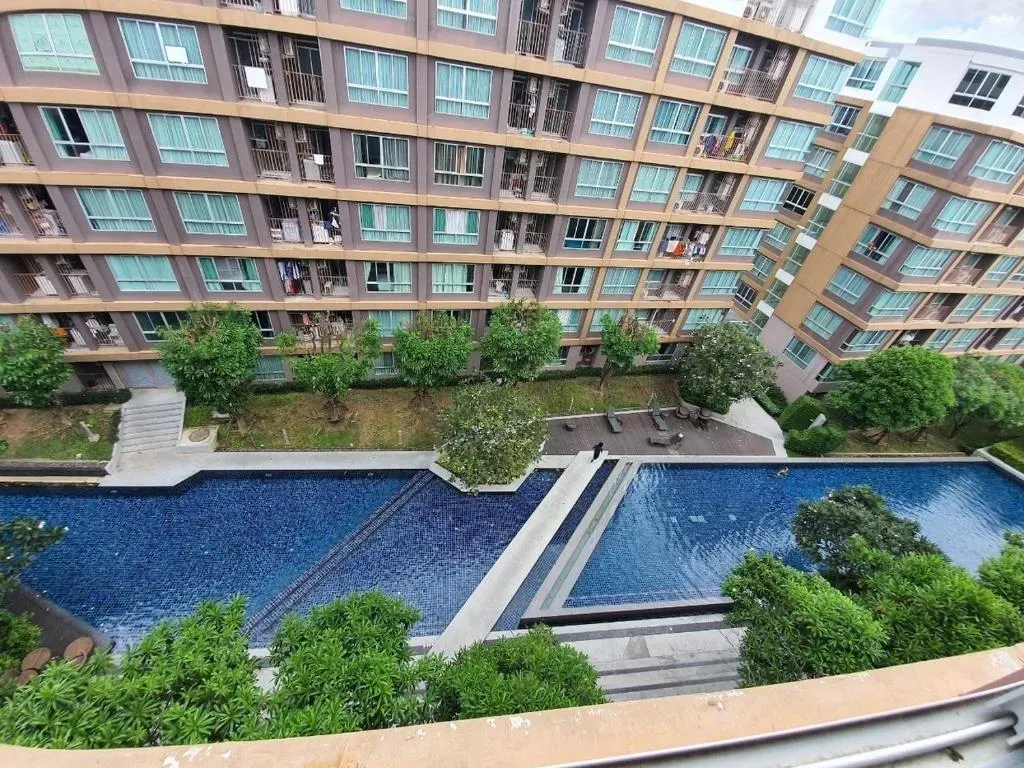 High-floor view over the sparkling swimming pool and surrounding buildings